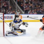 
              St. Louis Blues goalie Ville Husso (35) makes a save on Edmonton Oilers' Evander Kane (91) during the second period of an NHL hockey game Friday, April 1, 2022, in Edmonton, Alberta. (Jason Franson/The Canadian Press via AP)
            