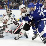 
              Tampa Bay Lightning center Ross Colton (79) gets off a shot as he battles with Chicago Blackhawks center Tyler Johnson (90), and defenseman Calvin de Haan (44) during the second period of an NHL hockey game Friday, April 1, 2022, in Tampa, Fla. (AP Photo/Chris O'Meara)
            