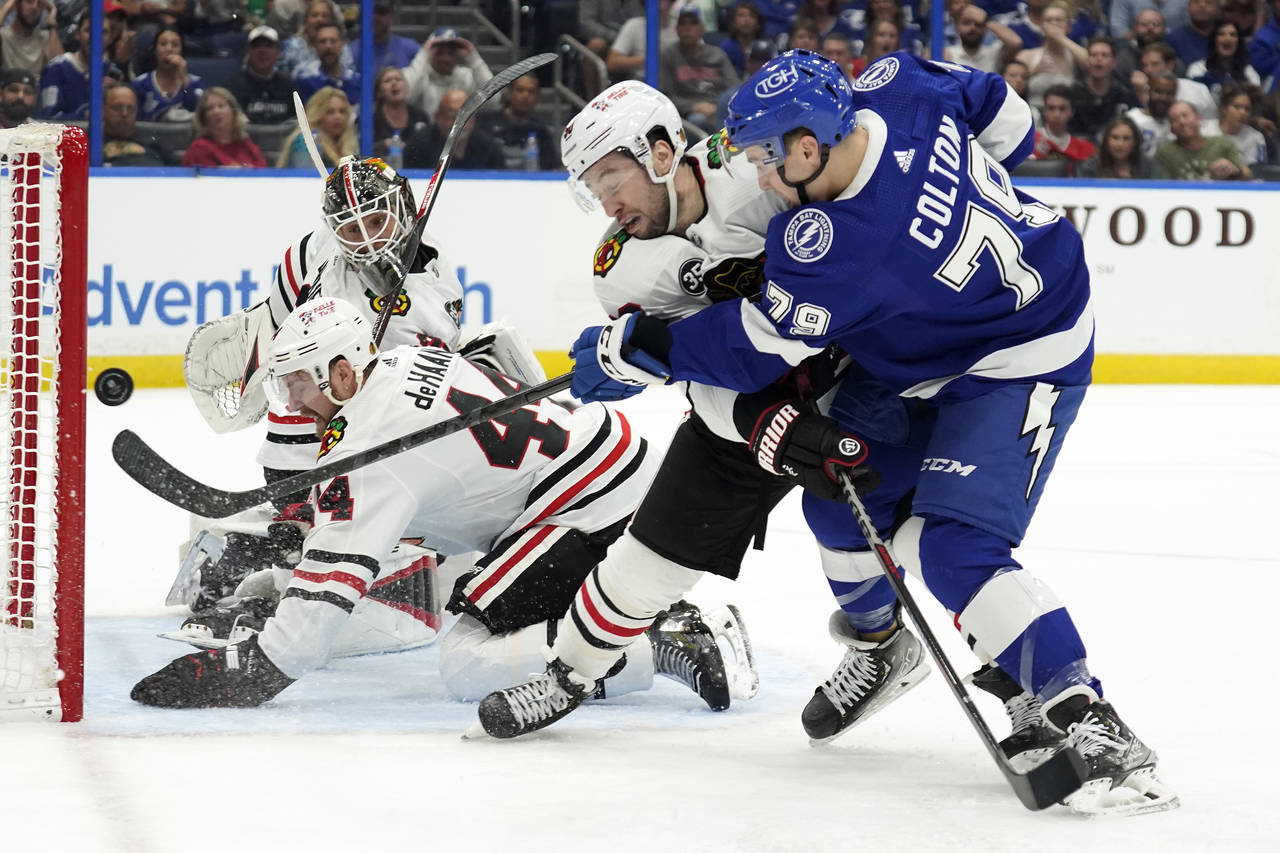 Tampa Bay Lightning center Ross Colton (79) gets off a shot as he battles with Chicago Blackhawks c...