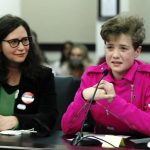 
              FILE - Fischer Wells, right, testifies against a bill would bar transgender girls from participating in school sports that match their gender identity, on Feb. 10, 2022, in Frankfort, Ky. Wells' mom Jenifer Alonzo listens at left. Kentucky's Democratic governor on Wednesday, April 6, 2022, vetoed a bill that would bar transgender girls and women from participating in school sports matching their gender identity from sixth grade through college. (Scott Utterback/Courier Journal via AP, File)
            