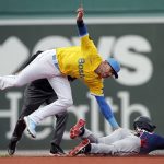 
              Boston Red Sox's Trevor Story, left, catches Minnesota Twins' Jorge Polanco who was trying to steal second base during the first inning of a baseball game, Saturday, April 16, 2022, in Boston. (AP Photo/Michael Dwyer)
            