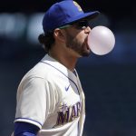 
              Seattle Mariners third baseman Eugenio Suarez blows a bubble with his gum during the first inning of a baseball game against the Houston Astros, Sunday, April 17, 2022, in Seattle. (AP Photo/Ted S. Warren)
            