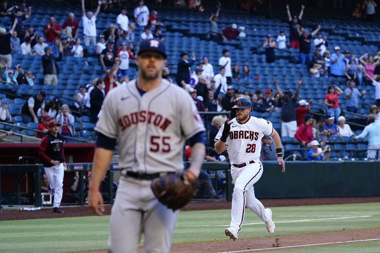 Arizona Diamondbacks' Seth Beer (28) heads home with the winning run as Houston Astros relief pitch...