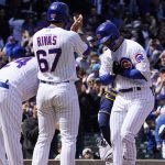 
              Chicago Cubs' Seiya Suzuki, right, runs the bases and is greeted by Jonathan Villar, left, and first baseman Alfonso Rivas (67) after hitting a three run home run against the Milwaukee Brewers during the first inning of a baseball game, Sunday, April, 10, 2022, in Chicago. (AP Photo/David Banks)
            