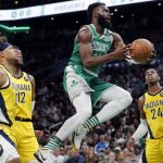 
              Boston Celtics' Jaylen Brown (7) shoots against Indiana Pacers' Tyrese Haliburton (0), Oshae Brissett (12) and Buddy Hield (24) during the first half of an NBA basketball game Friday, April 1, 2022, in Boston. (AP Photo/Michael Dwyer)
            