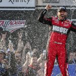 
              NASCAR Cup Series driver Ross Chastain (1) celebrates the win in Victory Lane following a NASCAR Cup Series auto race, Sunday, April 24, 2022, in Talladega, Ala. (AP Photo/Butch Dill)
            