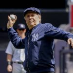
              Actor Billy Crystal throws the ceremonial first pitch before the New York Yankees opening day baseball game against the Boston Red Sox, Friday, April 8, 2022, in New York. (AP Photo/John Minchillo)
            