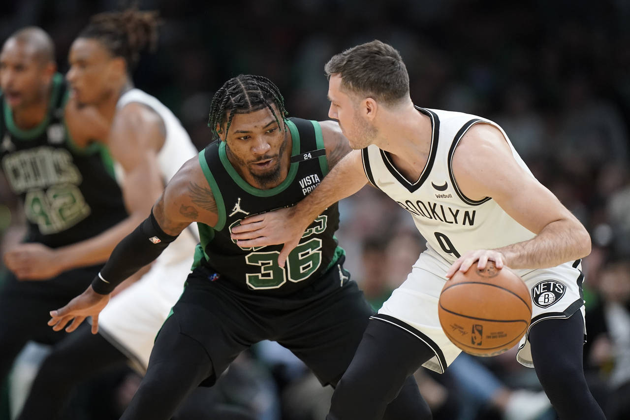 Boston Celtics guard Marcus Smart (36) defends as Brooklyn Nets guard Goran Dragic, of Slovenia, ri...