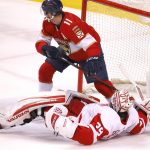 
              Florida Panthers left wing Jonathan Huberdeau (11) is penalized after running into Detroit Red Wings goaltender Alex Nedeljkovic (39) during the second period of an NHL hockey game Thursday, April 21, 2022, in Sunrise, Fla. (AP Photo/Reinhold Matay)
            