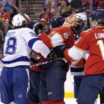 
              Tampa Bay Lightning left wing Brandon Hagel, left, pushes Florida Panthers left wing Mason Marchment, center, during the first period of an NHL hockey game, Sunday, April 24, 2022, in Sunrise, Fla. Hagel was penalized on the play. (AP Photo/Lynne Sladky)
            