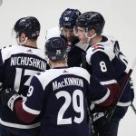 
              Colorado Avalanche defenseman Cale Makar, right, is congratulated by right wing Valeri Nichushkin, left, center Nathan MacKinnon, front center, and center Nazem Kadri for Makar's goal during the first period of an NHL hockey game against the Nashville Predators on Thursday, April 28, 2022, in Denver. (AP Photo/David Zalubowski)
            