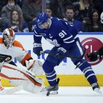 
              Philadelphia Flyers goaltender Martin Jones (35) makes a save on Toronto Maple Leafs forward John Tavares (91) as defenseman Keith Yandle (3) joins the action during the third period of an NHL hockey game Tuesday, April 19, 2022 in Toronto. (Nathan Denette/The Canadian Press via AP)
            