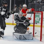 
              Los Angeles Kings forward Phillip Danault (24) and goalie Cal Petersen (40) look at the puck during the first period of an NHL hockey game against the Calgary Flames, Monday, April 4, 2022, in Los Angeles. (AP Photo/Ringo H.W. Chiu)
            
