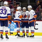 
              New York Islanders' Jean-Gabriel Pageau (44), center, is congratulated on his goal be teammates Kyle Palmieri (21), Matt Martin (17), and Zdeno Chara (33) during the second period of an NHL hockey game against the Carolina Hurricanes in Raleigh, N.C., Friday, April 8, 2022. (AP Photo/Karl B DeBlaker)
            