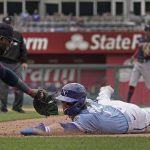 
              Kansas City Royals' Bobby Witt Jr. is tagged out by Minnesota Twins first baseman Miguel Sano as he dives back to first after being caught off base during the fifth inning of a baseball game Thursday, April 21, 2022, in Kansas City, Mo. (AP Photo/Charlie Riedel)
            