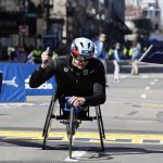 
              Daniel Romanchuck, of the United States, breaks the tape to win the Mens Wheelchair Division of the 126th Boston Marathon, Monday, April 18, 2022, in Boston. (AP Photo/Winslow Townson)
            