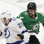 
              Dallas Stars left wing Jamie Benn (14) fights with Tampa Bay Lightning left wing Nicholas Paul (20) during the first period of an NHL hockey game in Dallas, Tuesday, April 12, 2022. (AP Photo/LM Otero)
            