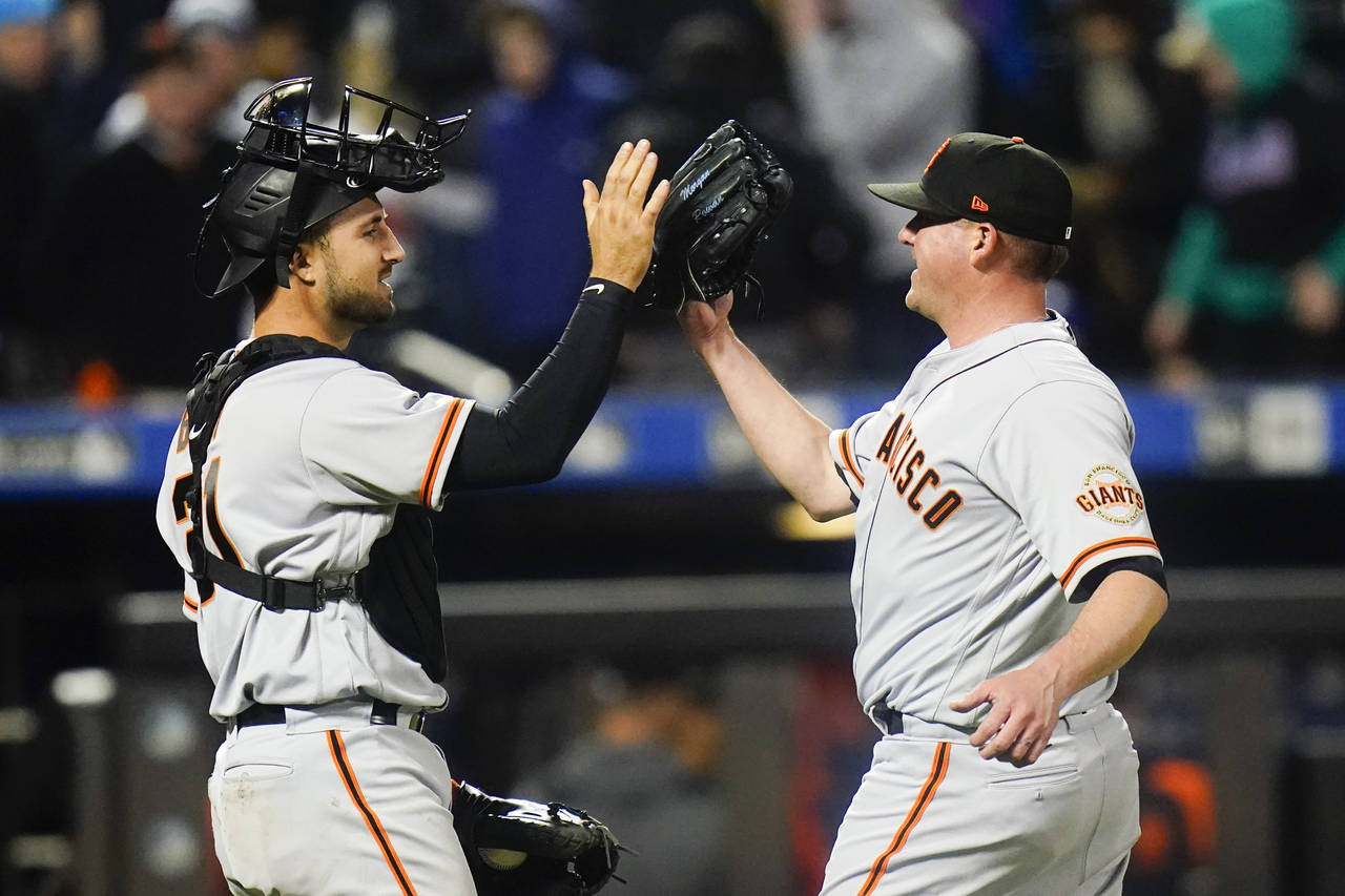 San Francisco Giants catcher Joey Bart, left, celebrates with relief pitcher Jake McGee after the t...