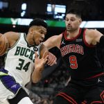 
              Milwaukee Bucks' Giannis Antetokounmpo tries to get past Chicago Bulls' Nikola Vucevic during the first half of Game 1 of their first round NBA playoff basketball game Sunday, April 17, 2022, in Milwaukee. (AP Photo/Morry Gash)
            