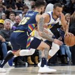 
              Golden State Warriors guard Stephen Curry, right, drives past Denver Nuggets guard Austin Rivers in the first half of Game 4 of an NBA basketball first-round Western Conference playoff series, Sunday, April 24, 2022, in Denver. (AP Photo/David Zalubowski)
            