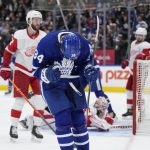 
              Toronto Maple Leafs center Auston Matthews (34) celebrates after scoring on Detroit Red Wings goaltender Alex Nedeljkovic (39)during the second period of an NHL hockey game in Toronto, Tuesday, April 26, 2022. (Frank Gunn/The Canadian Press via AP)
            