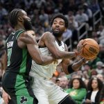 
              Boston Celtics guard Jaylen Brown, left, defends against Brooklyn Nets guard Kyrie Irving, right, in the second half of Game 1 of an NBA basketball first-round Eastern Conference playoff series, Sunday, April 17, 2022, in Boston. The Celtics won 115-114. (AP Photo/Steven Senne)
            