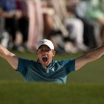 
              Rory McIlroy, of Northern Ireland, reacts after holing out from the bunker for a birdie during the final round at the Masters golf tournament on Sunday, April 10, 2022, in Augusta, Ga. (AP Photo/David J. Phillip)
            