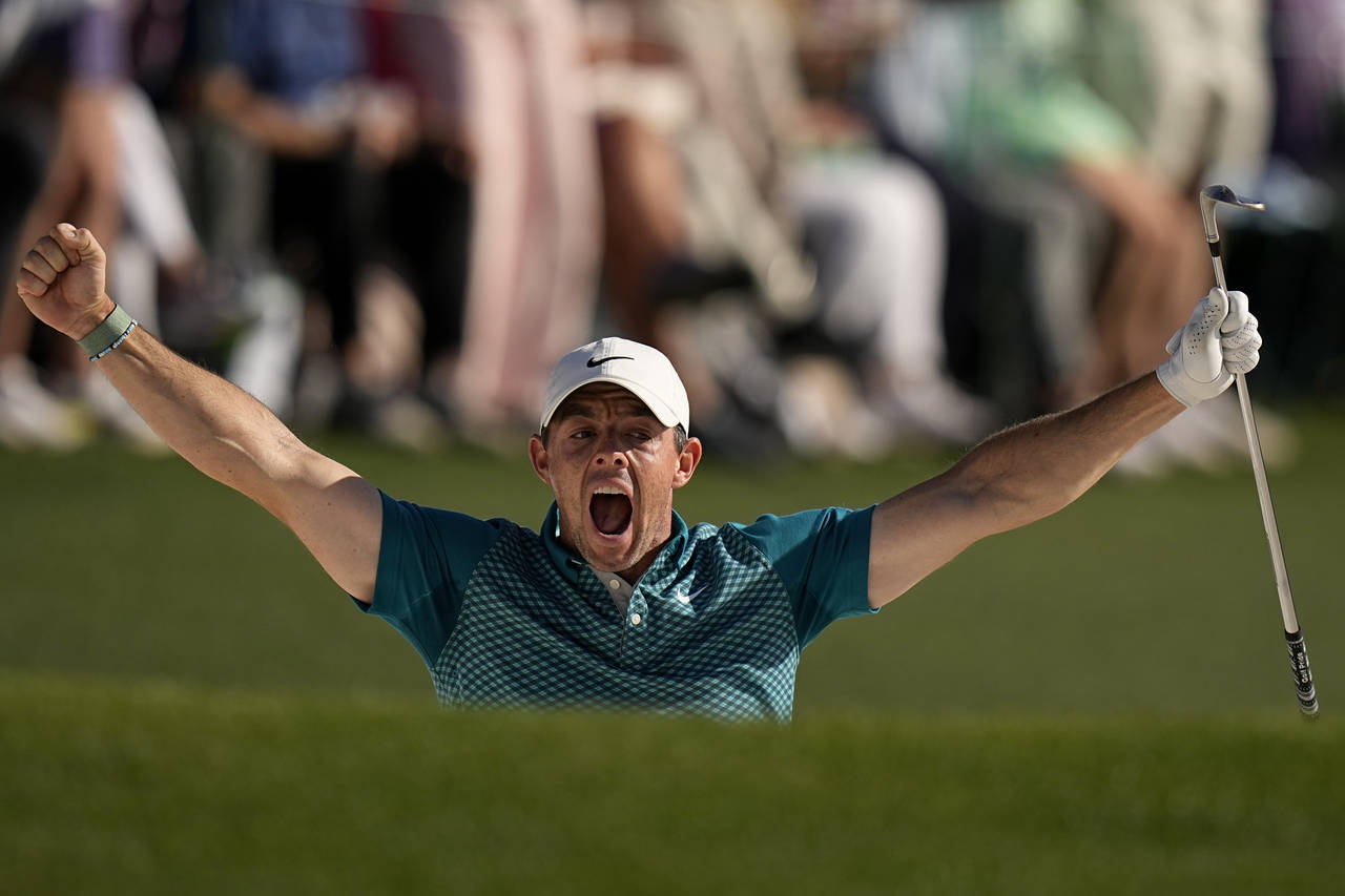 Rory McIlroy, of Northern Ireland, reacts after holing out from the bunker for a birdie during the ...