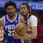 
              Cleveland Cavaliers center Moses Brown, right, rebounds against Philadelphia 76ers guard Matisse Thybulle (22) in the first half of an NBA basketball game, Sunday, April 3, 2022, in Cleveland. (AP Photo/David Dermer)
            