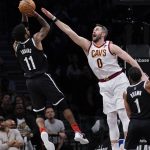 
              Cleveland Cavaliers' Kevin Love, right, tries to block a shot by Brooklyn Nets' Kyrie Irving during the first half of the opening basketball game of the NBA play-in tournament Tuesday, April 12, 2022, in New York. (AP Photo/Seth Wenig)
            