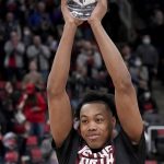 
              NBA Rookie of the Year, Toronto Raptors forward Scottie Barnes (4) holds up the trophy prior to the first half of Game 4 of an NBA basketball first-round playoff series against the Philadelphia 76ers, Saturday, April 23, 2022 in Toronto. (Nathan Denette/The Canadian Press via AP)
            