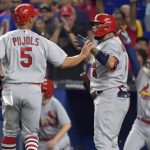 
              St. Louis Cardinals' Albert Pujols (5) is greeted by Yadier Molina after scoring during the second inning of the team's baseball game against the Miami Marlins, Tuesday, April 19, 2022, in Miami. (AP Photo/Jim Rassol)
            