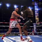 
              Britain’s Tyson Fury, left, lands a blow on Britain’s Dillian Whyte during their WBC heavyweight title boxing fight at Wembley Stadium in London, Saturday, April 23, 2022. (Nick Potts/PA via AP)
            