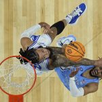 
              Duke forward Theo John, right, blocks the shot of North Carolina guard R.J. Davis during the first half of a college basketball game in the semifinal round of the Men's Final Four NCAA tournament, Saturday, April 2, 2022, in New Orleans. (AP Photo/Brynn Anderson)
            