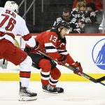 
              New Jersey Devils center Nico Hischier (13) controls the puck as Carolina Hurricanes defenseman Brady Skjei (76) defends during the first period of an NHL hockey game Saturday, April 23, 2022, in Newark, N.J. (AP Photo/Bill Kostroun)
            