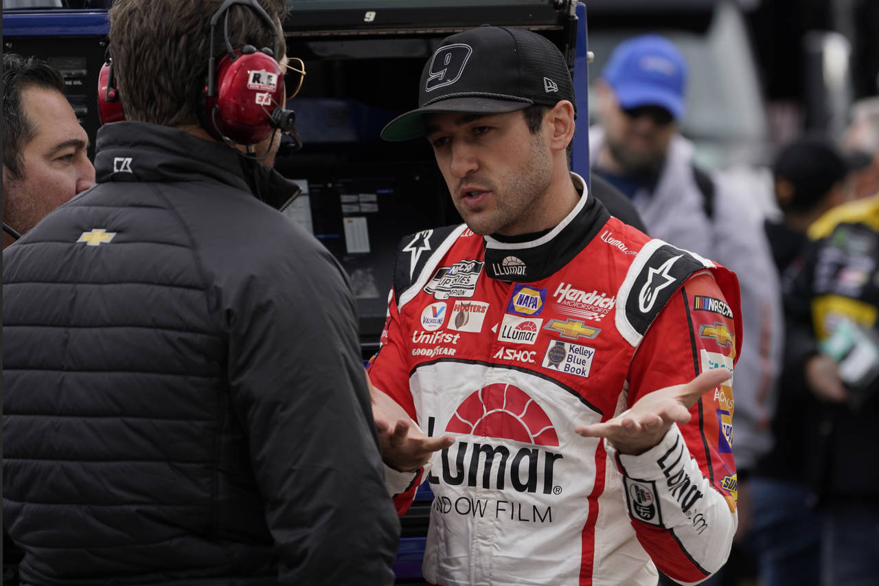 Chase Elliott talks with a team member prior to qualifying for Saturday's NASCAR Cup Series auto ra...