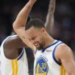 
              Golden State Warriors guard Stephen Curry, front, congratulates forward Draymond Green near the endoof Game 3 of the team's NBA basketball first-round Western Conference playoff series against the Denver Nuggets Thursday, April 21, 2022, in Denver. (AP Photo/David Zalubowski)
            