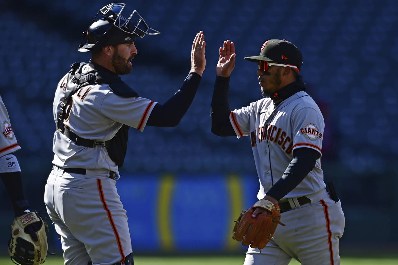 San Francisco Giants second basemen Thairo Estrada, right, is congratulated by catcher Curt Casali ...
