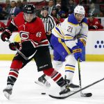 
              Buffalo Sabres' Jacob Bryson (78) tips the puck away from Carolina Hurricanes' Teuvo Teravainen (86) with Sabres' Kyle Okposo (21) defending during the second period of an NHL hockey game in Raleigh, N.C., Thursday, April 7, 2022. (AP Photo/Karl B DeBlaker)
            