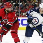 
              The puck nears the face of Carolina Hurricanes' Jordan Staal (11) as Winnipeg Jets' Dylan Samberg (54) watches during the second period of an NHL hockey game in Raleigh, N.C., Thursday, April 21, 2022. (AP Photo/Karl B DeBlaker)
            