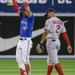 
              Toronto Blue Jays' Gosuke Katoh celebrates after hitting a double, next to Boston Red Sox shortstop Xander Bogaerts during the fourth inning of a baseball game Wednesday, April 27, 2022, in Toronto. (Christopher Katsarov/The Canadian Press via AP)
            