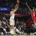 
              Los Angeles Clippers forward Nicolas Batum, left, shoots as New Orleans Pelicans forward Brandon Ingram defends during the first half of an NBA basketball game Sunday, April 3, 2022, in Los Angeles. (AP Photo/Mark J. Terrill)
            