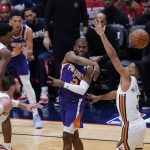 
              Phoenix Suns guard Chris Paul (3) passes between New Orleans Pelicans center Jonas Valanciunas (17) and guard CJ McCollum (3) in the first half of game 6 of an NBA basketball first-round playoff series, Thursday, April 28, 2022 in New Orleans. (AP Photo/Gerald Herbert)
            