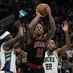 
              Chicago Bulls' DeMar DeRozan shoots past Milwaukee Bucks' Jrue Holiday during the second half of Game 1 of their first round NBA playoff basketball game Sunday, April 17, 2022, in Milwaukee. The Bucks won 93-86 to take a 1-0 lead in the series. (AP Photo/Morry Gash)
            