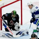 
              Arizona Coyotes goaltender Harri Sateri (30) makes a save in front of Vancouver Canucks right wing William Lockwood (58) during the first period of an NHL hockey game Thursday, April 7, 2022, in Glendale, Ariz. (AP Photo/Ross D. Franklin)
            