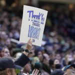 
              A fan holds a sign that reads "Thank you inaugural Kraken team," during the second period of an NHL hockey game between the Seattle Kraken and the San Jose Sharks, Friday, April 29, 2022, in Seattle. (AP Photo/Ted S. Warren)
            