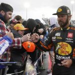 
              Martin Truex Jr. greets fans during driver introductions before the NASCAR Cup Series auto race at Martinsville Speedway on Saturday, April 9, 2022, in Martinsville, Va. (AP Photo/Steve Helber)
            