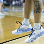
              North Carolina guard R.J. Davis (4) with a tatoo of Malcom X warms up during practice for the men's Final Four NCAA college basketball tournament, Friday, April 1, 2022, in New Orleans. (AP Photo/Brynn Anderson)
            