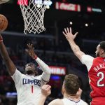 
              Los Angeles Clippers guard Reggie Jackson, left, shoots as New Orleans Pelicans forward Larry Nance Jr. defends during the second half of an NBA basketball game Sunday, April 3, 2022, in Los Angeles. (AP Photo/Mark J. Terrill)
            