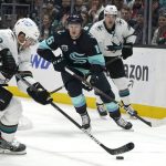 
              Seattle Kraken left wing Jared McCann, center, closes in on San Jose Sharks left wing Matt Nieto (83) during the second period of an NHL hockey game Friday, April 29, 2022, in Seattle. (AP Photo/Ted S. Warren)
            